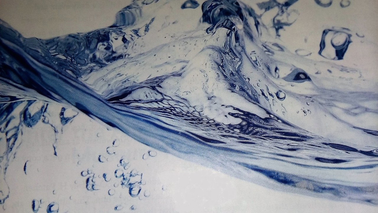 View of a splash of water with bubbles below the surface.
