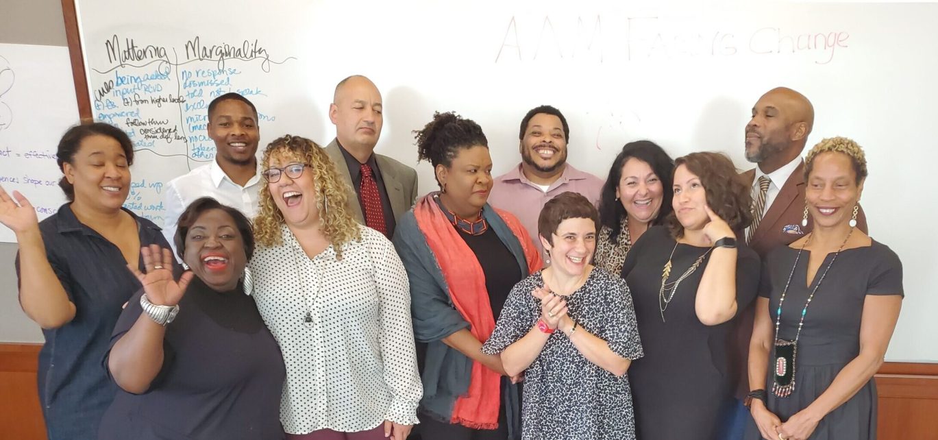 A candid photo of the 10 Senior Diversity Fellows and the two DEAI Project Manager