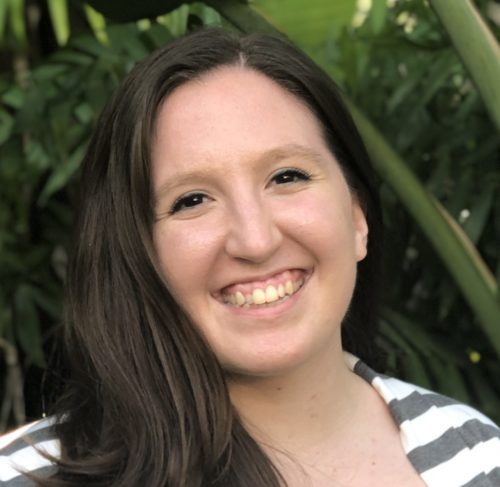 Headshot of Abigail Winslow, a white woman with long dark brown hair wearing a striped shirt.