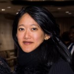 Headshot of Helen Yuen, an Asian woman with long dark hair wearing a dark colored shirt. 