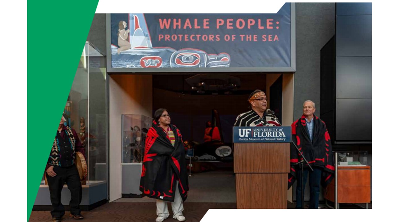 Several indigenous people stand ourtside of the Whale People Protection of the Sea exhibition.