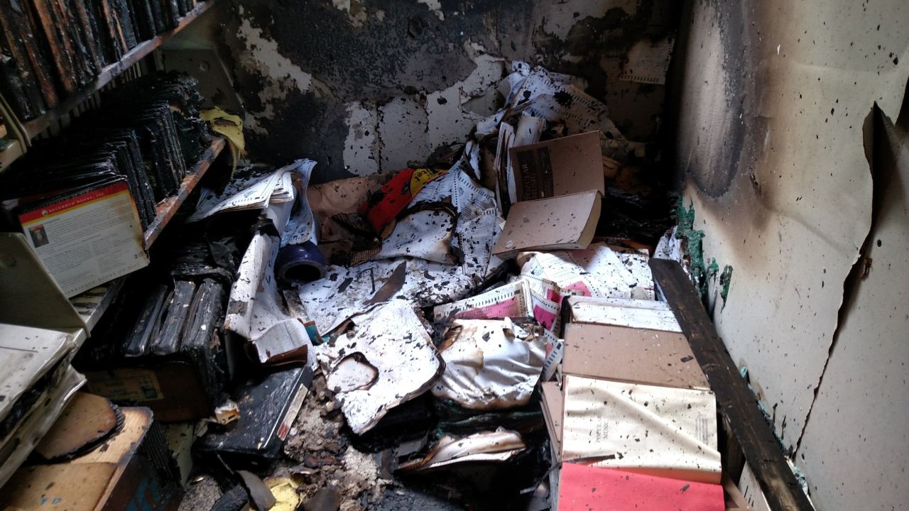 A heap of burned materials on the ground.