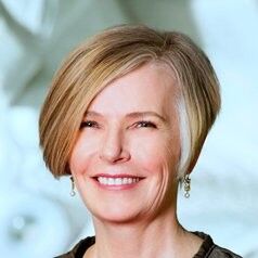 IMage of Alison Brown, a white woman with short blond hair smiling broadly at the camera.