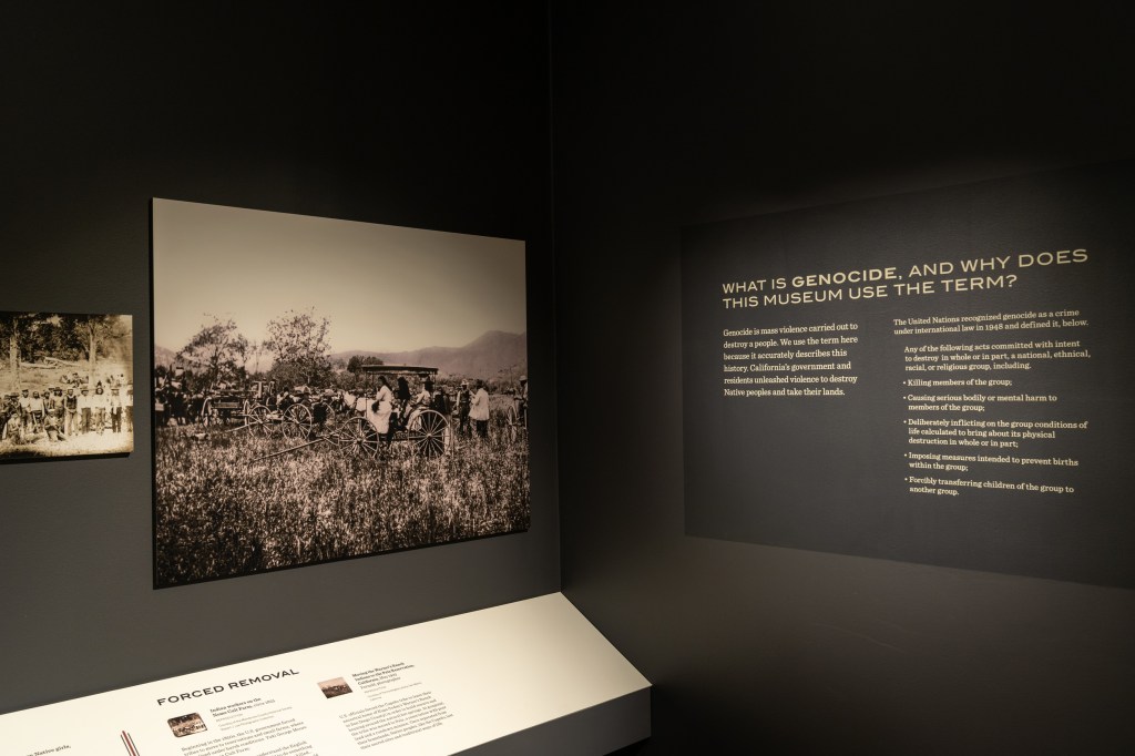 A corner of the gallery has a sign which reads "What is genocide, and why does this museum use the term?" with information about the definition of genocide beneath.