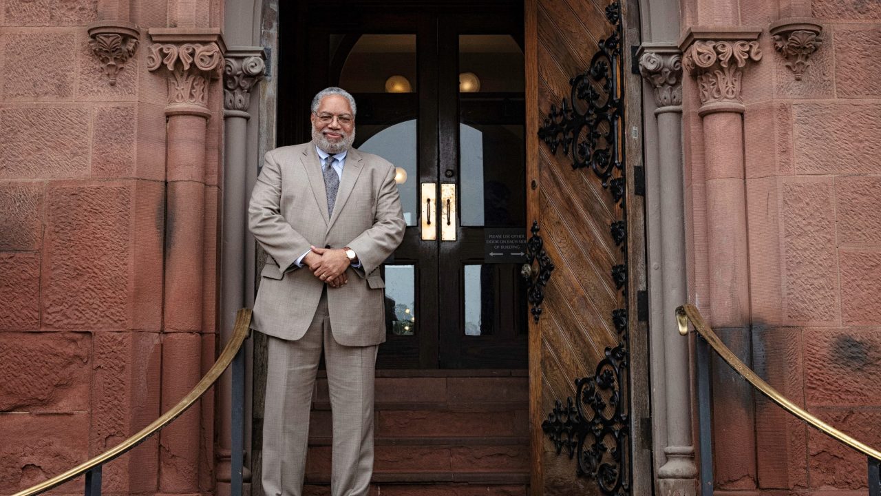 Lonnie Bunch stands on the steps of the Smithsonian Castle.