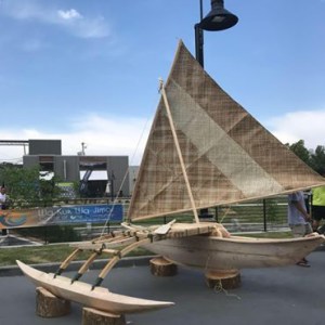 The boat is displayed near a stage for the event.