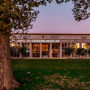 Facade of Queens Museum with great lawn space visible