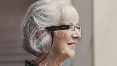 A woman wearing glasses attached to a cord.