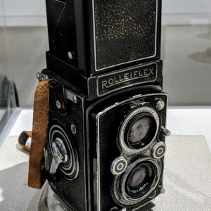An antique camera on display in a museum.