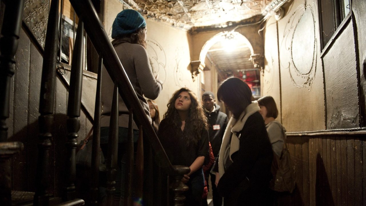 A tour group in a historic tenement at the Tenement Museum