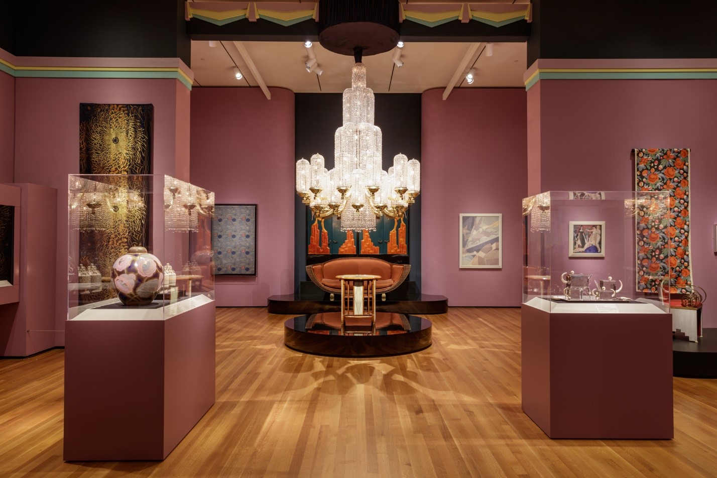 A gallery from the exhibition The Jazz Age: American Style in the 1920s, with decorative arts like a chandelier, furniture, and ceramics on display.