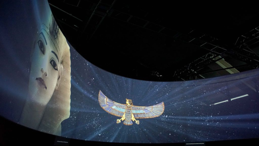 A large wraparound screen with an animated video showing King Tut and artifacts from his tomb