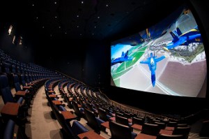A theater with a screen showing a film of animated planes