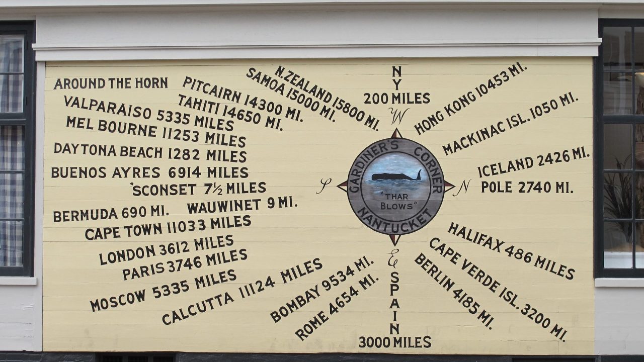 A sign showing the distance from Nantucket to other locations by sea.