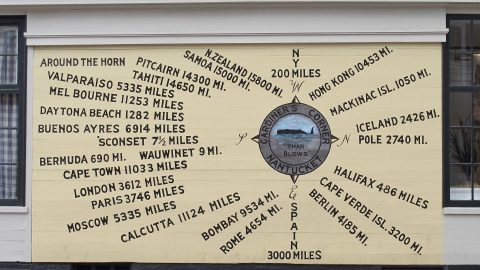 A sign showing the distance from Nantucket to other locations by sea.