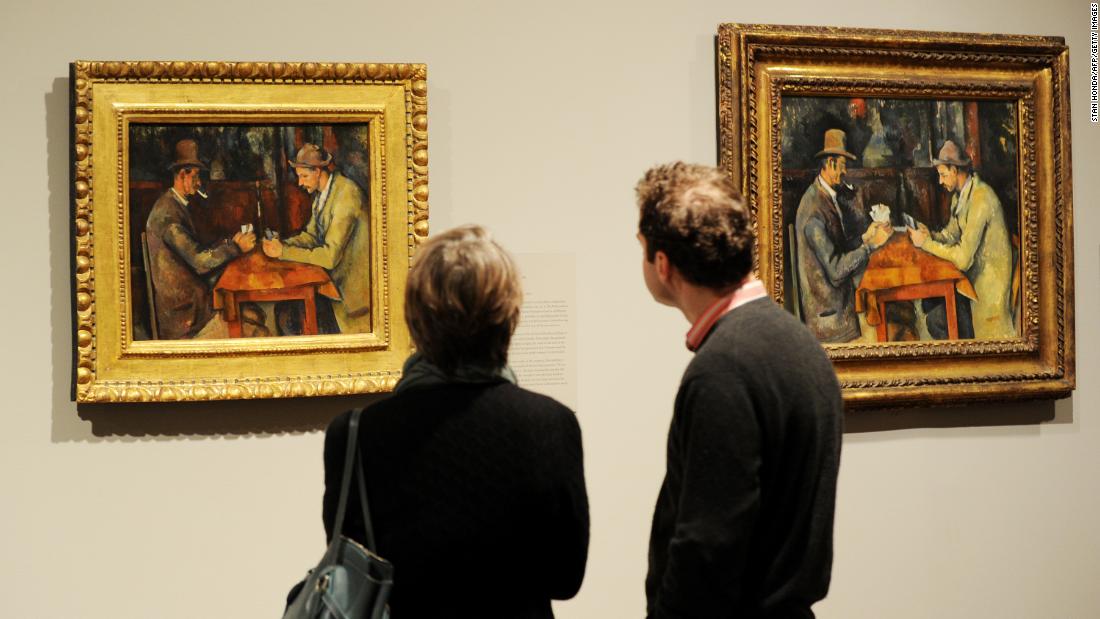 2 people looking at a painting