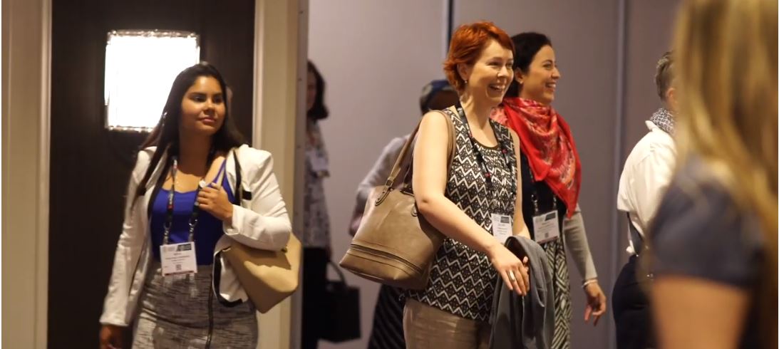 Several attendees at the AAM Annual Meeting and MuseumExpo leaving a room smiling.
