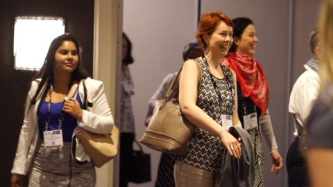 Several attendees at the AAM Annual Meeting and MuseumExpo leaving a room smiling.