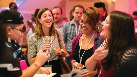 A group of people drinking and smiling.