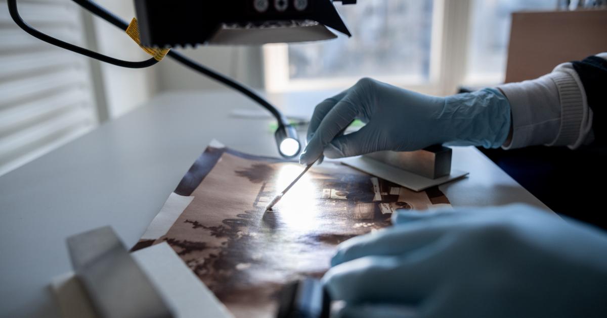 A museum conservator at work. Photo by Fabian Strauch/picture alliance via Getty Images.