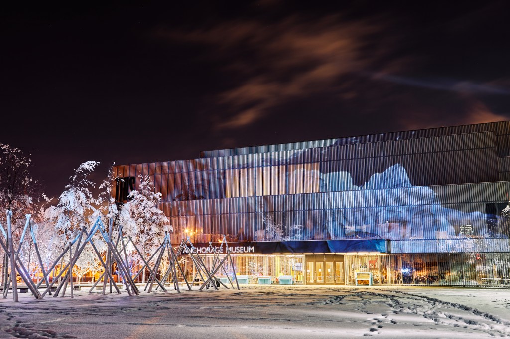 The museum facade seen at night with video of glaciers projected over it