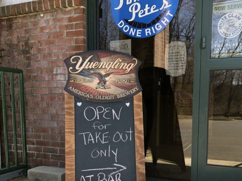 The exterior of a restaurant called "Pomona Pete's" with a sidewalk sign reading "Open for Take Out Only at Bar"