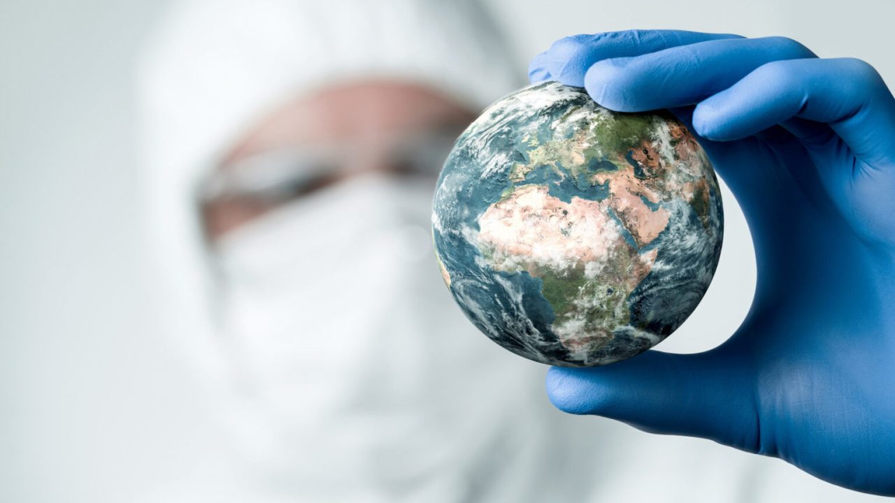 Scientist holding a model of planet Earth