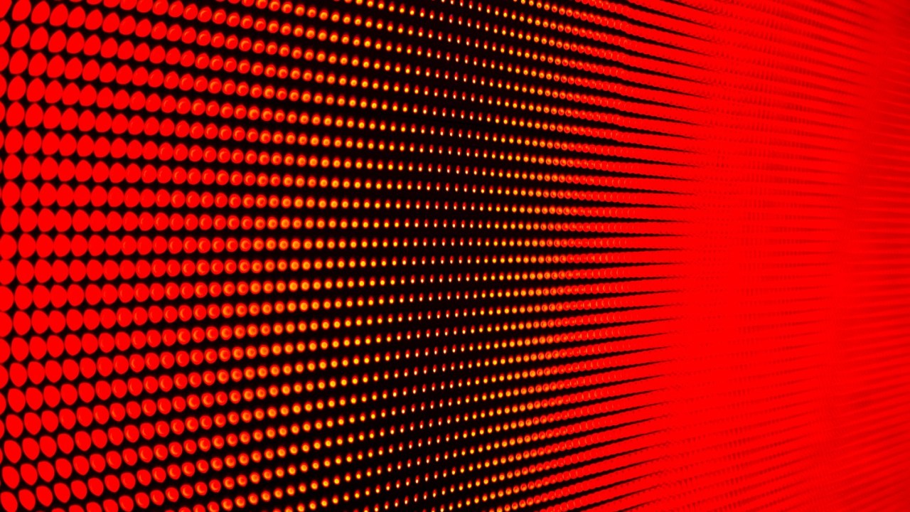 Small red lighted dots displayed in a grid, shown from an angle.