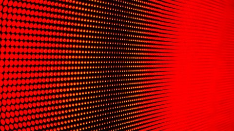 Small red lighted dots displayed in a grid, shown from an angle.