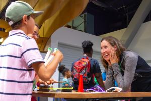 children playing in museum and woman laughing