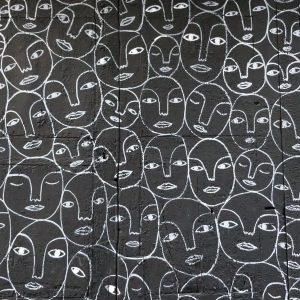 A mural of stylized faces drawn on a wall