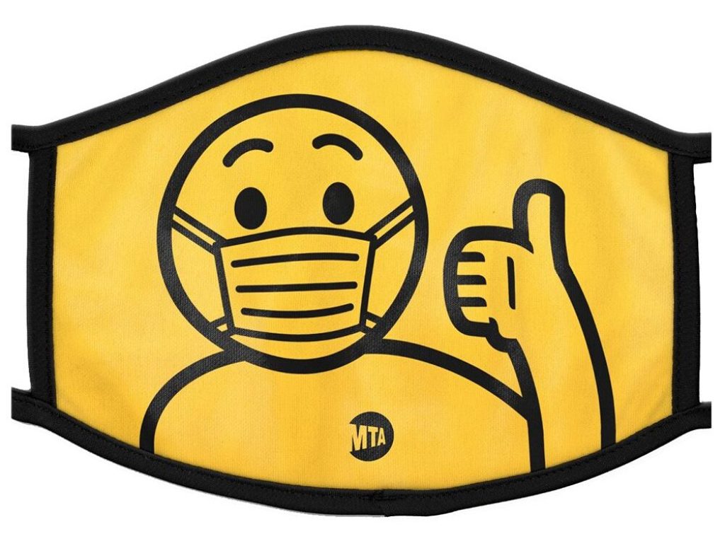 A yellow mask with black piping and a design of a human figure wearing an MTA t-shirt and flashing a thumbs up sign.