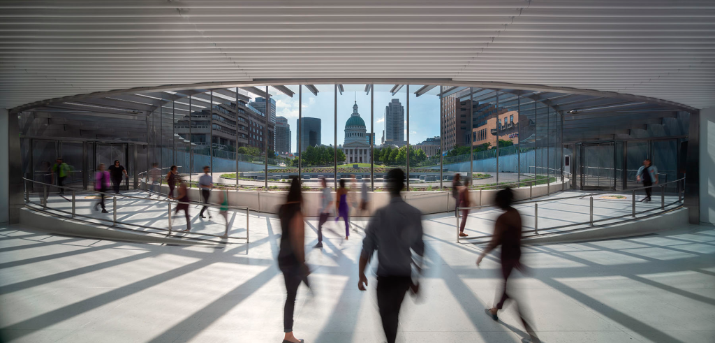 A lobby with a round design and floor-to-ceiling glass walls