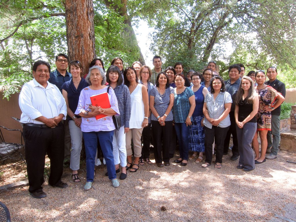 A large group of people posing in an outdoor courtyard