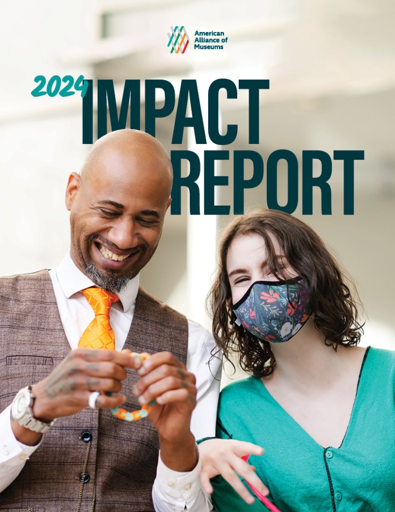 Cover of 2024 Impact Report is two museum staff members smiling together. 