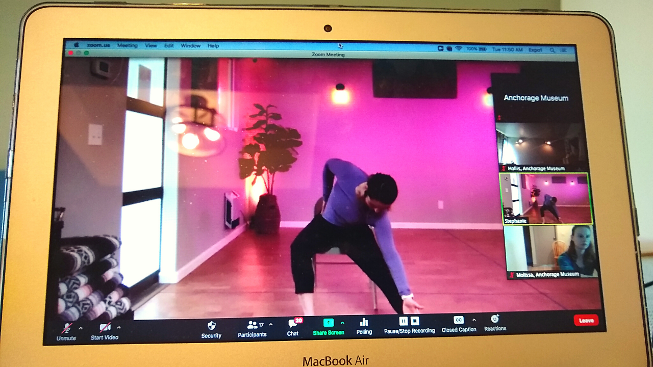 A Zoom screen open to an instructor in a dance studio modeling a stretch movement