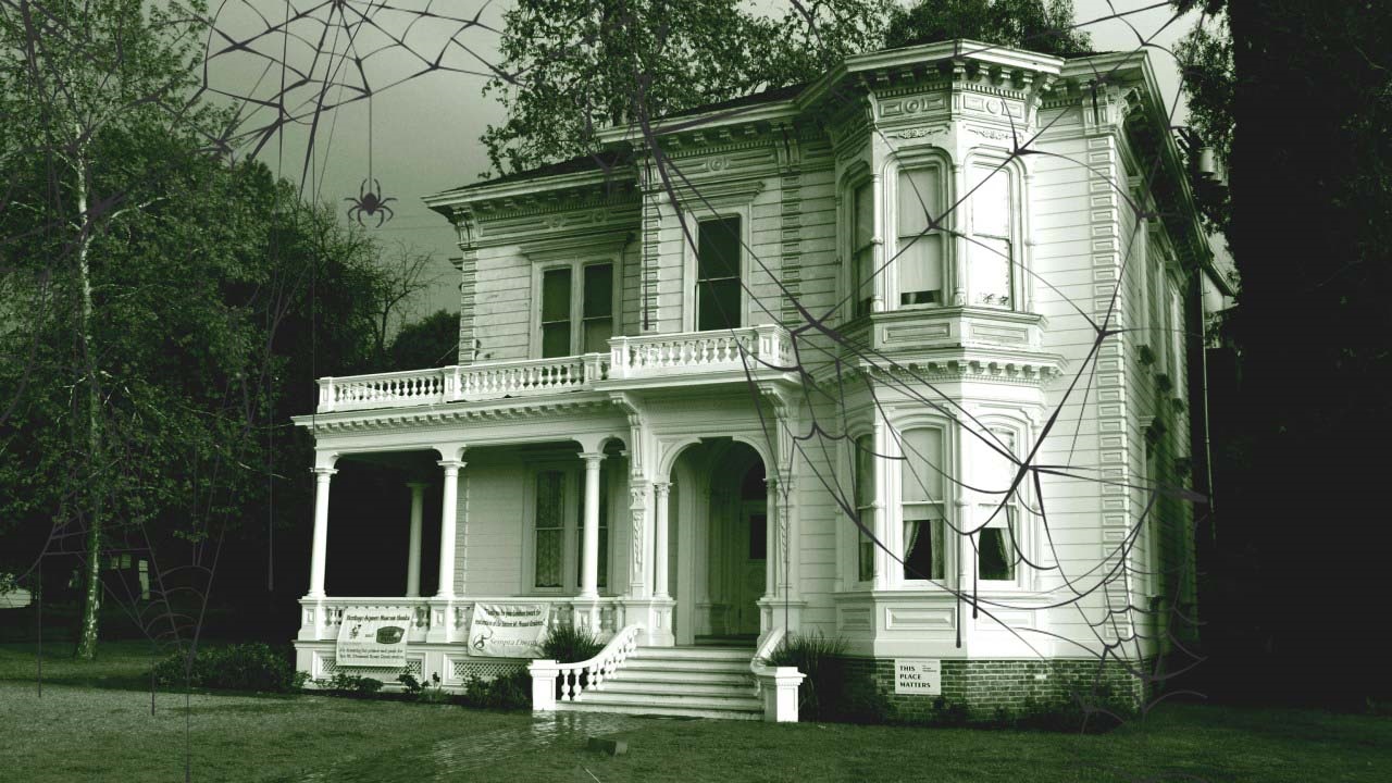 A sepia-colored photograph of a Victorian mansion