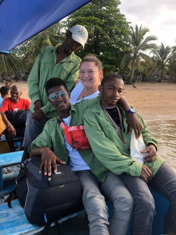 Staff posing on a boat