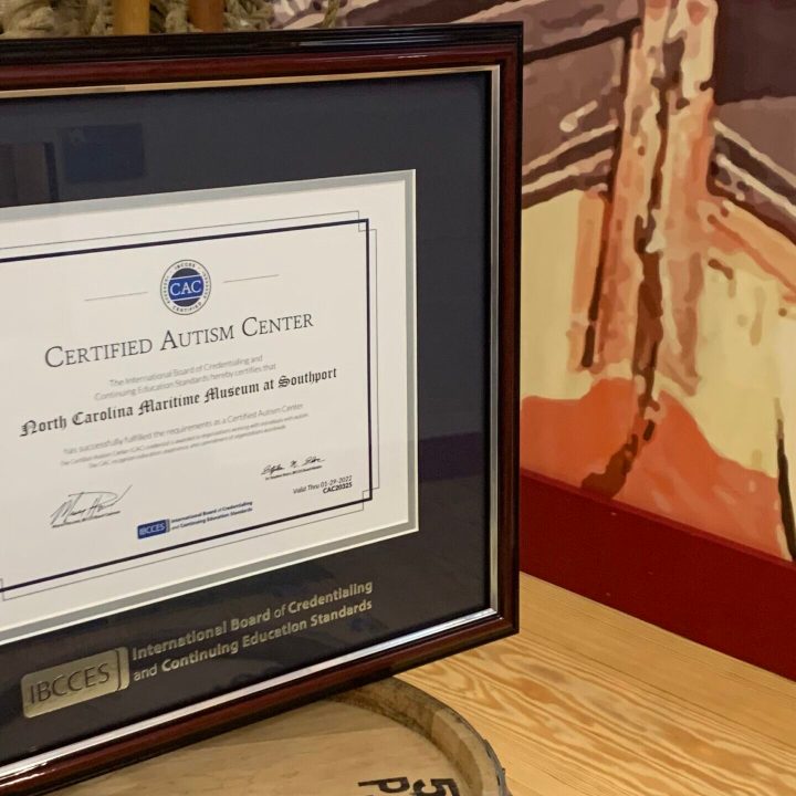 A plaque displayed in a museum gallery recognizing the museums as a Certified Autism Center