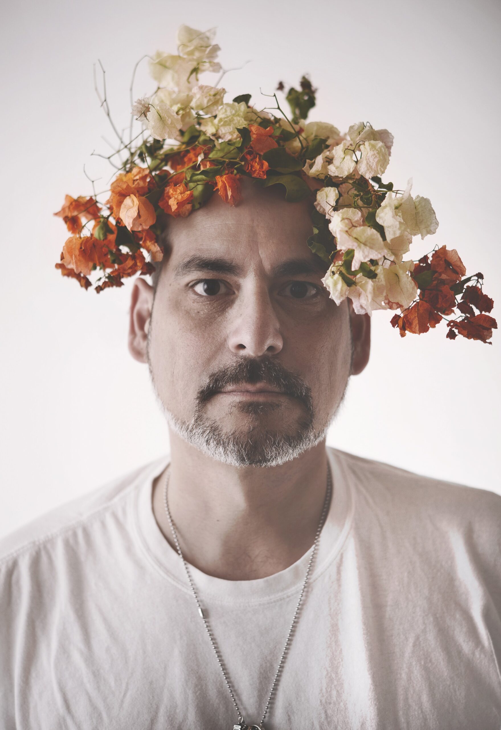 Headshot of Franklin Vagnone, wearing a flower crown