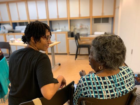 Two people in conversation seen from behind