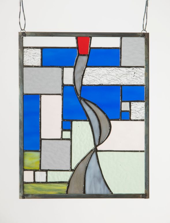A stained glass piece with abstract grid and curved lines