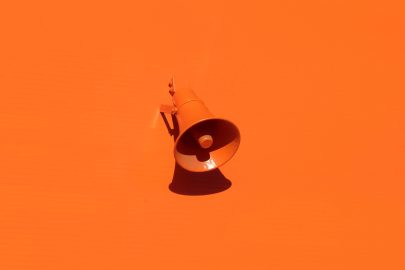An orange megaphone on an orange background
