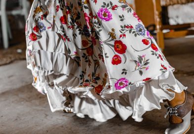 The hem of a salsa dancer's dress with one shoe poised to do a move