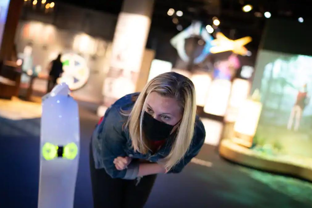 Lucy Stirn, a Spy Museum employee, talks to a hospitalized child who is using the robot to visit the museum. (Sarah L. Voisin/The Washington Post)