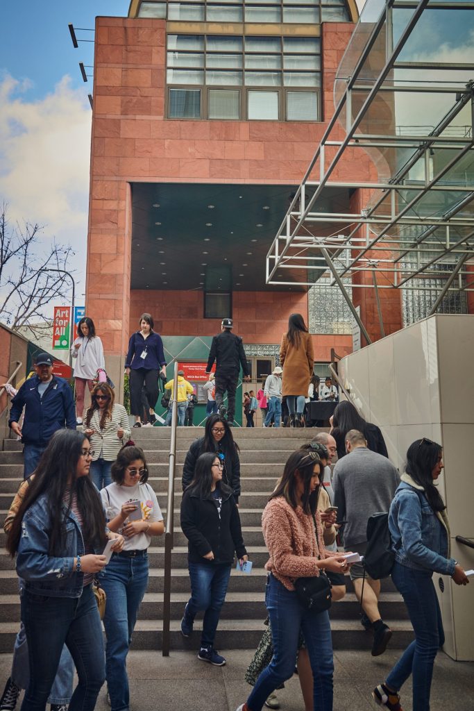 Exterior of the MOCA building with a crowd of visitors coming and going