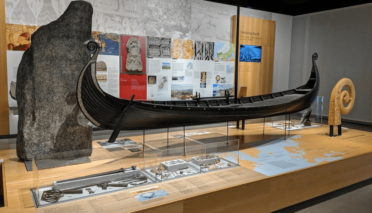 A museum gallery display with small objects inside of glass cases