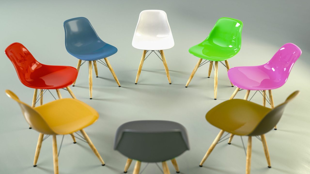 A group of multicolored chairs arranged in a circle