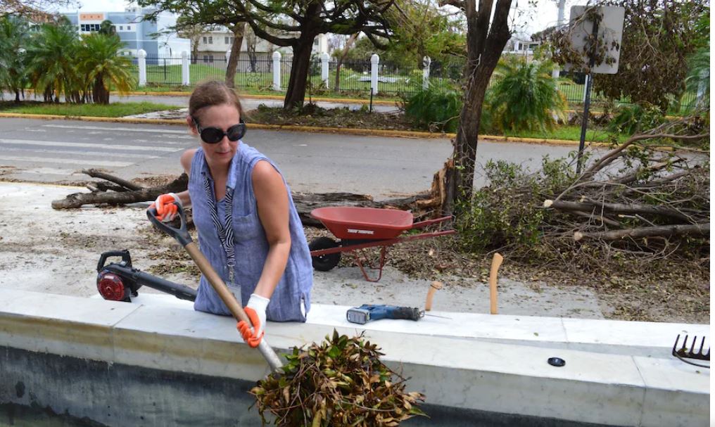Alejandra Peña-Gutiérrez, executive director of the Museo de Arte de Ponce, works to clean up the museum grounds after Hurricane Maria in 2017. (Museo de Arte de Ponce)
