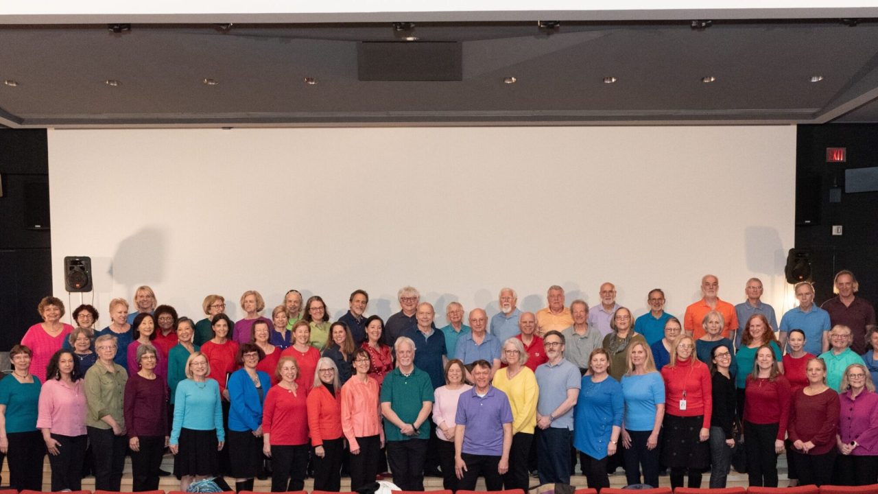 A group portrait of senior participants wearing colorful shirts